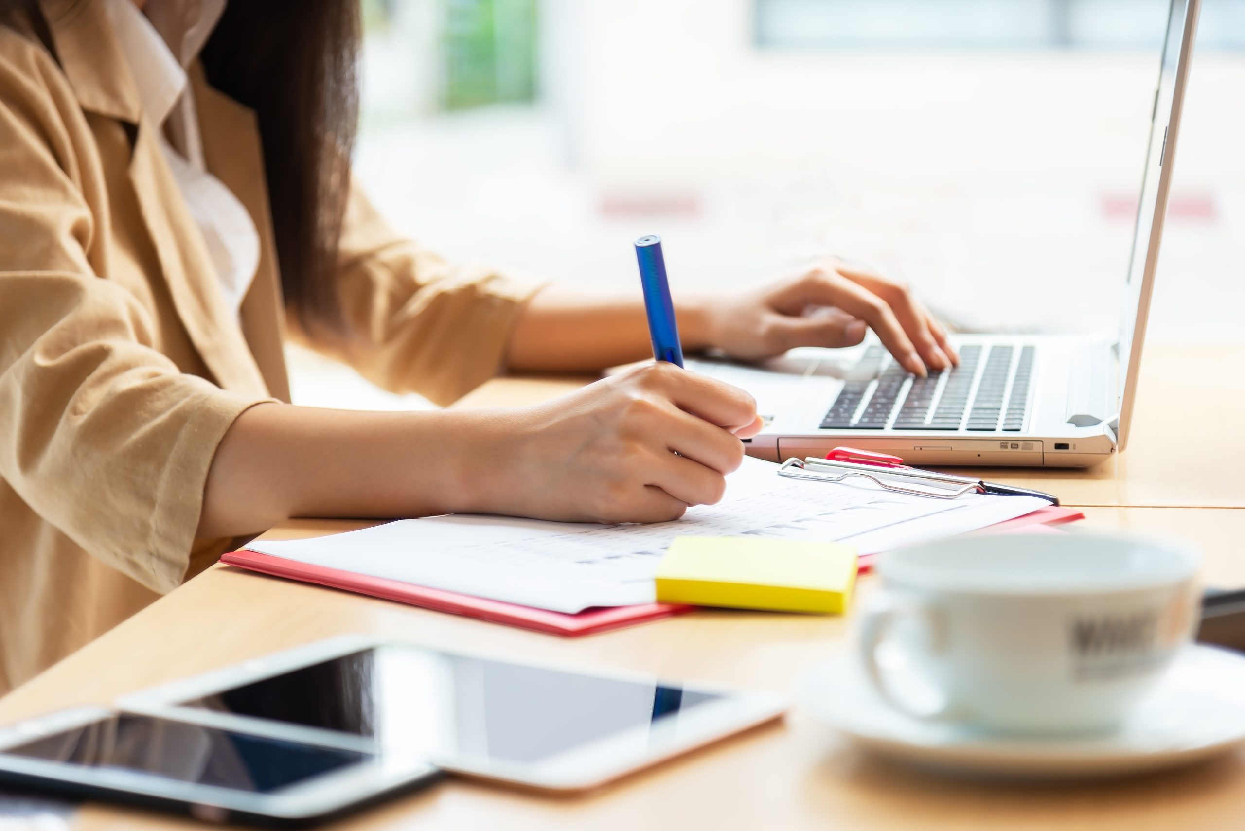 women writing in notebook