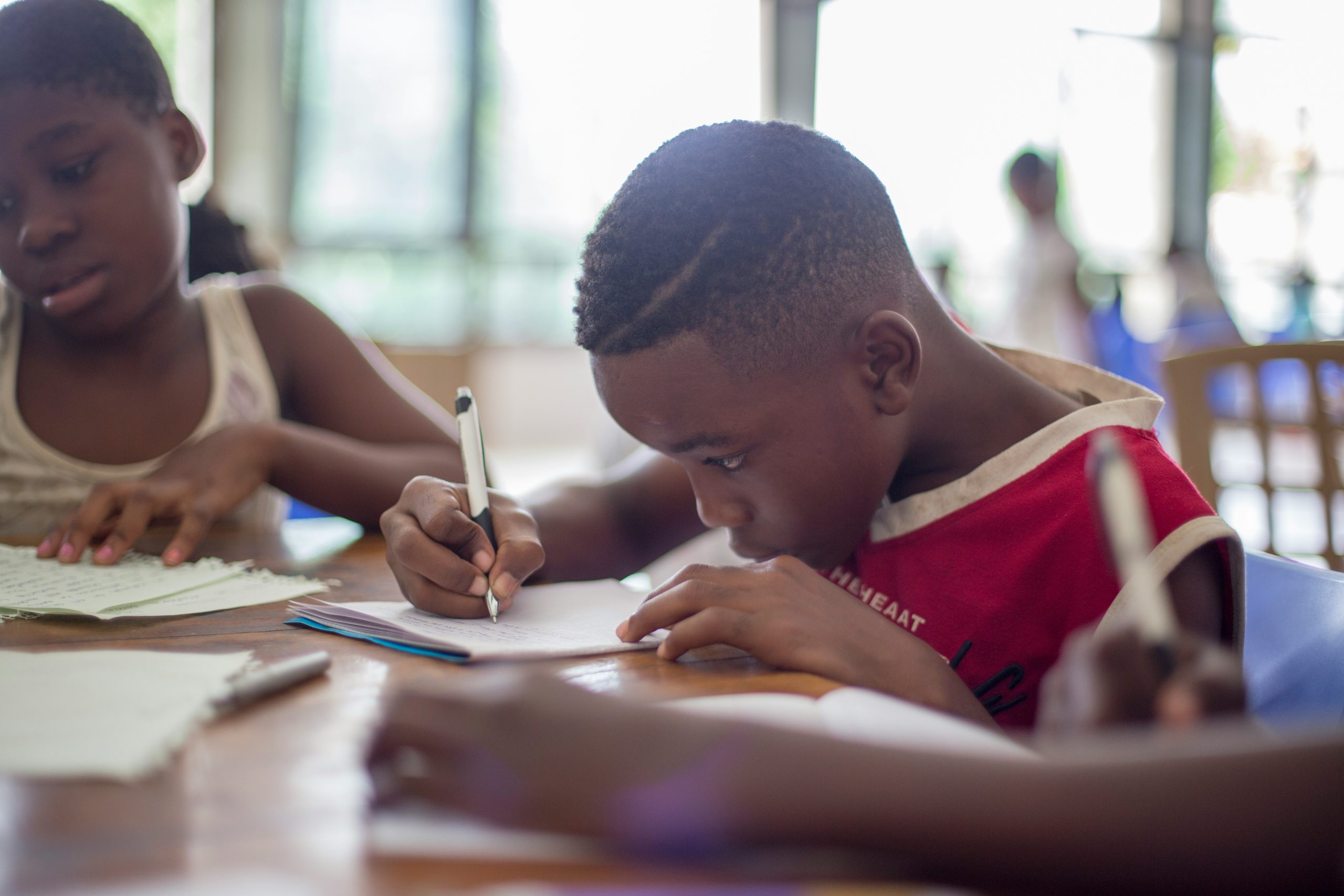 Young boy and girl writing